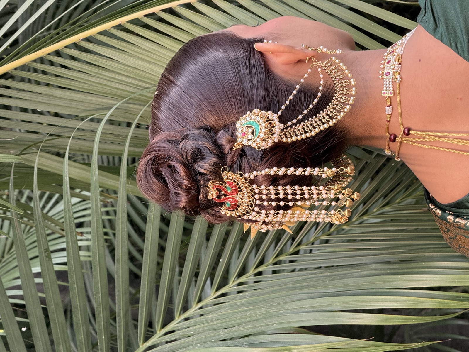 Bun styled with pearls and flowers, back view