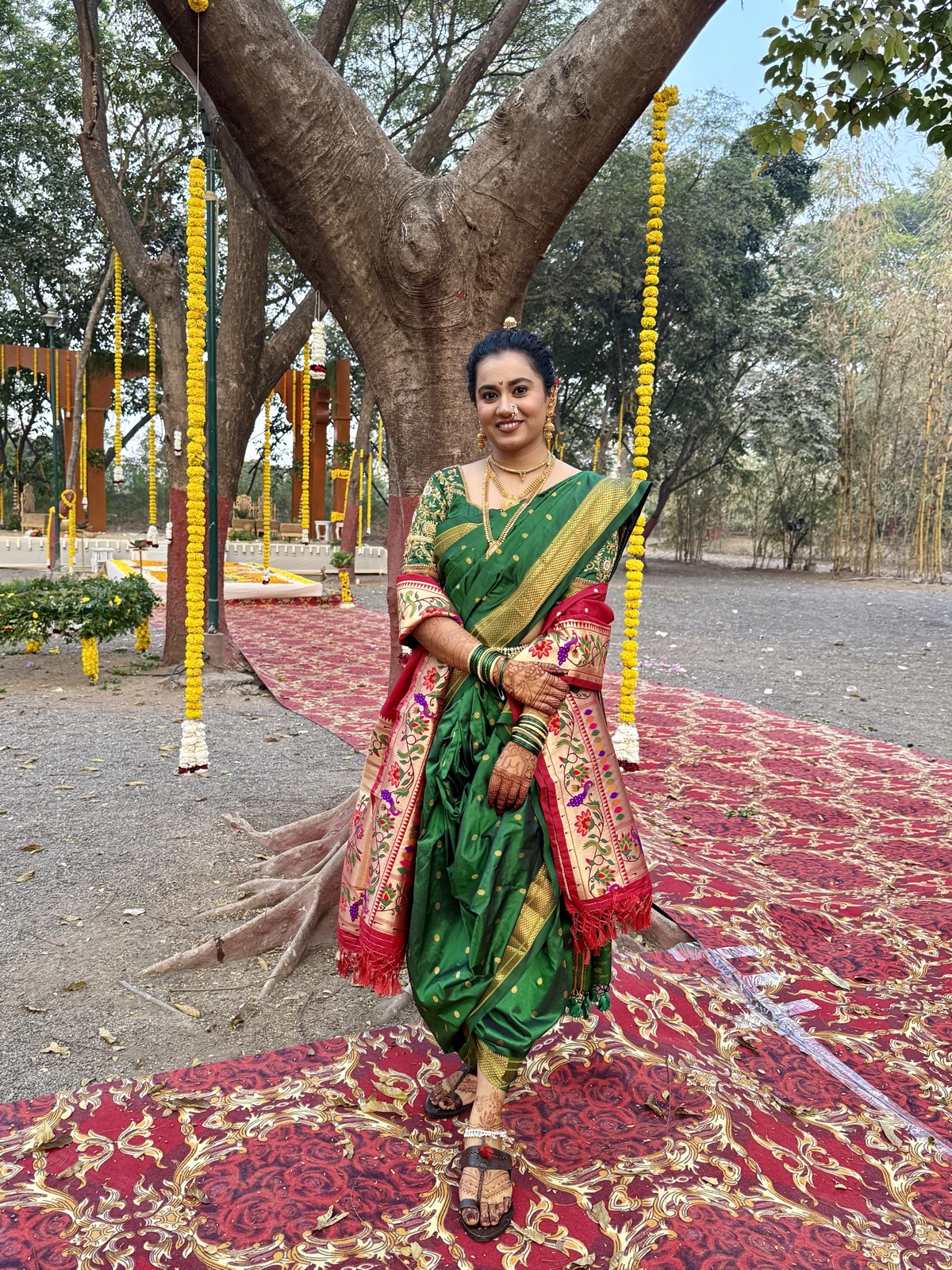 Bride in a green nauvari saree, full-length wedding-day look