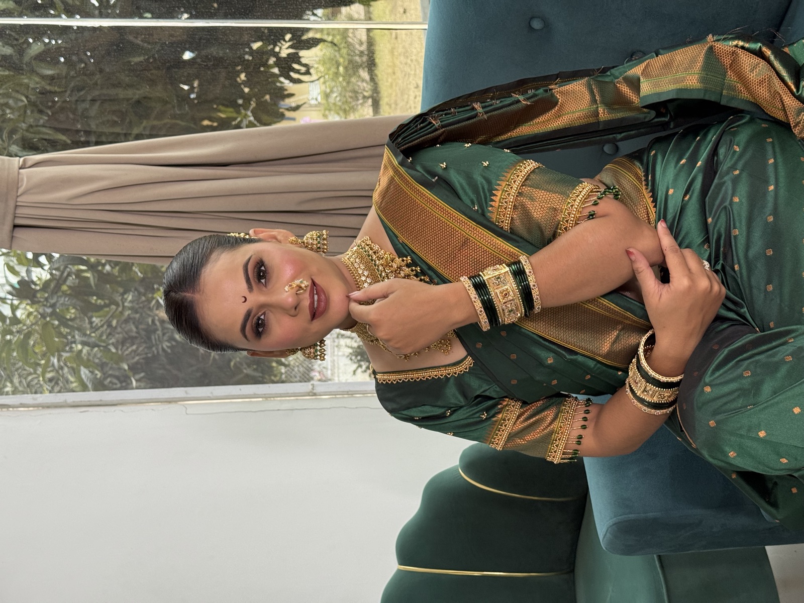 Traditional Maharashtrian look in a green saree with green bangles and gold