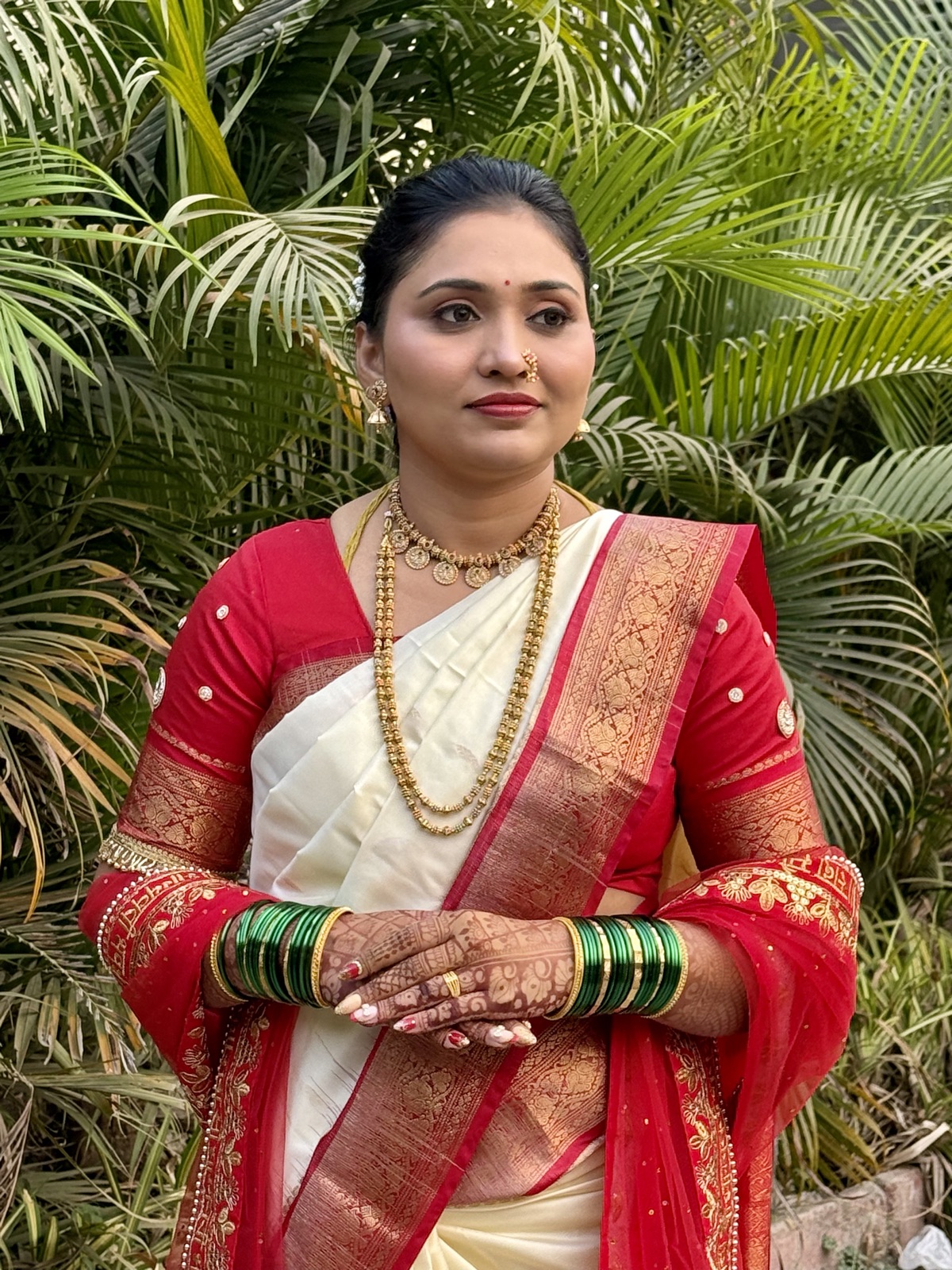 Traditional Maharashtrian look in a red nauvari saree with pearl jewellery