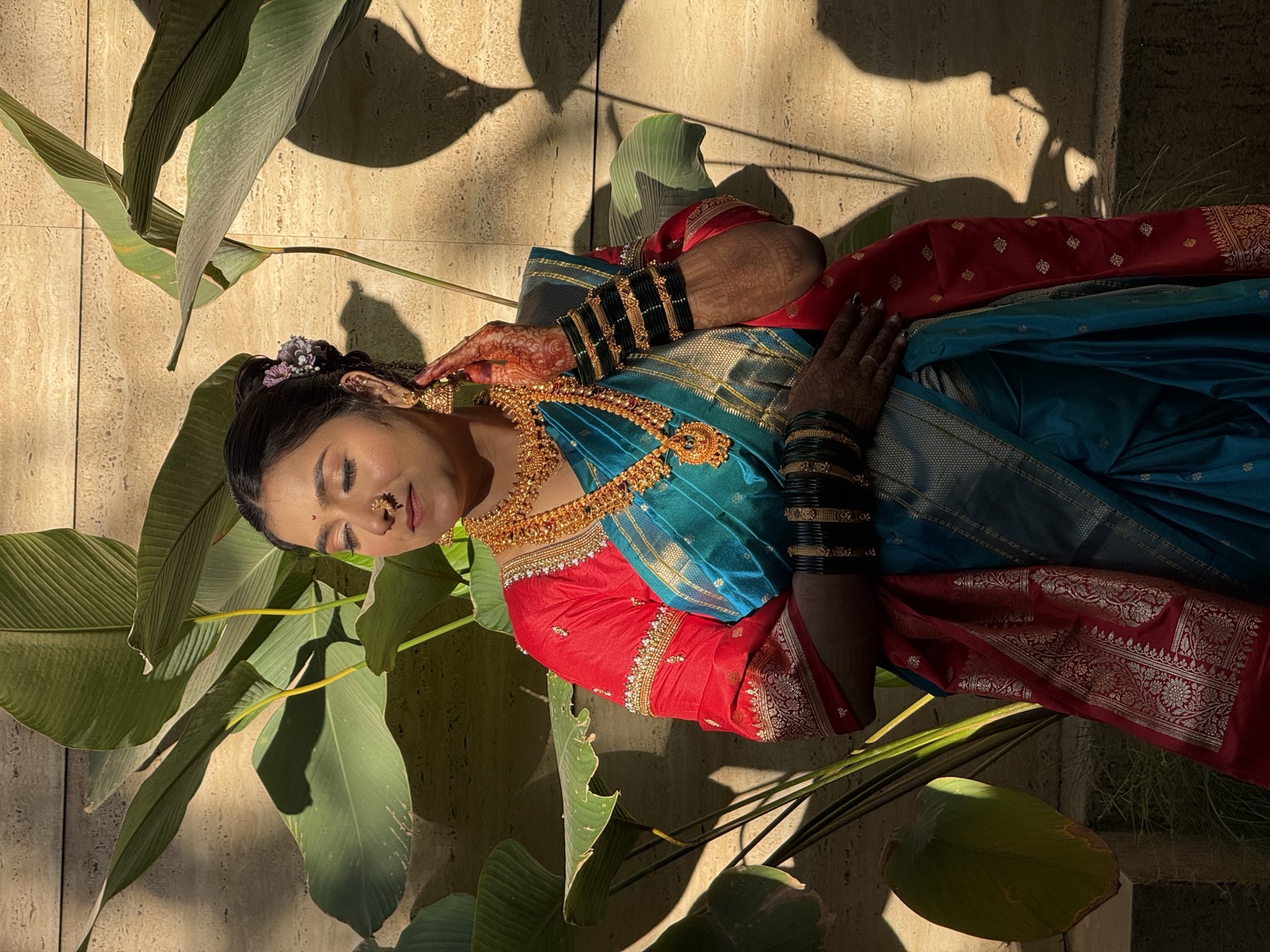 Traditional Maharashtrian look in a teal nauvari saree with mehendi