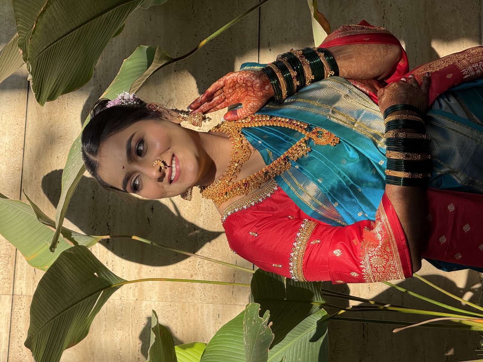 Traditional Maharashtrian look in a teal nauvari saree with gold jewellery