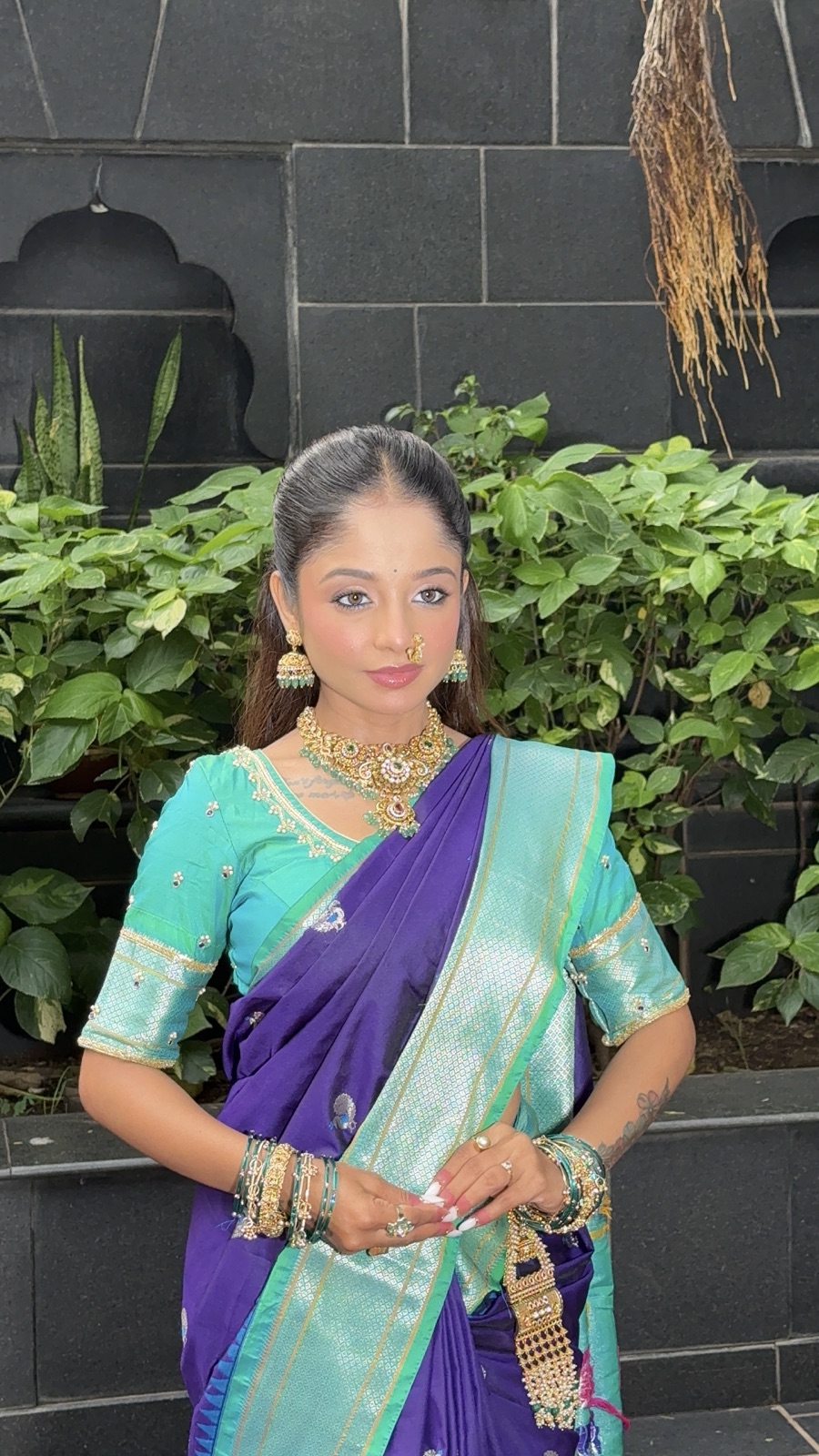 Party guest look in a purple-and-teal saree