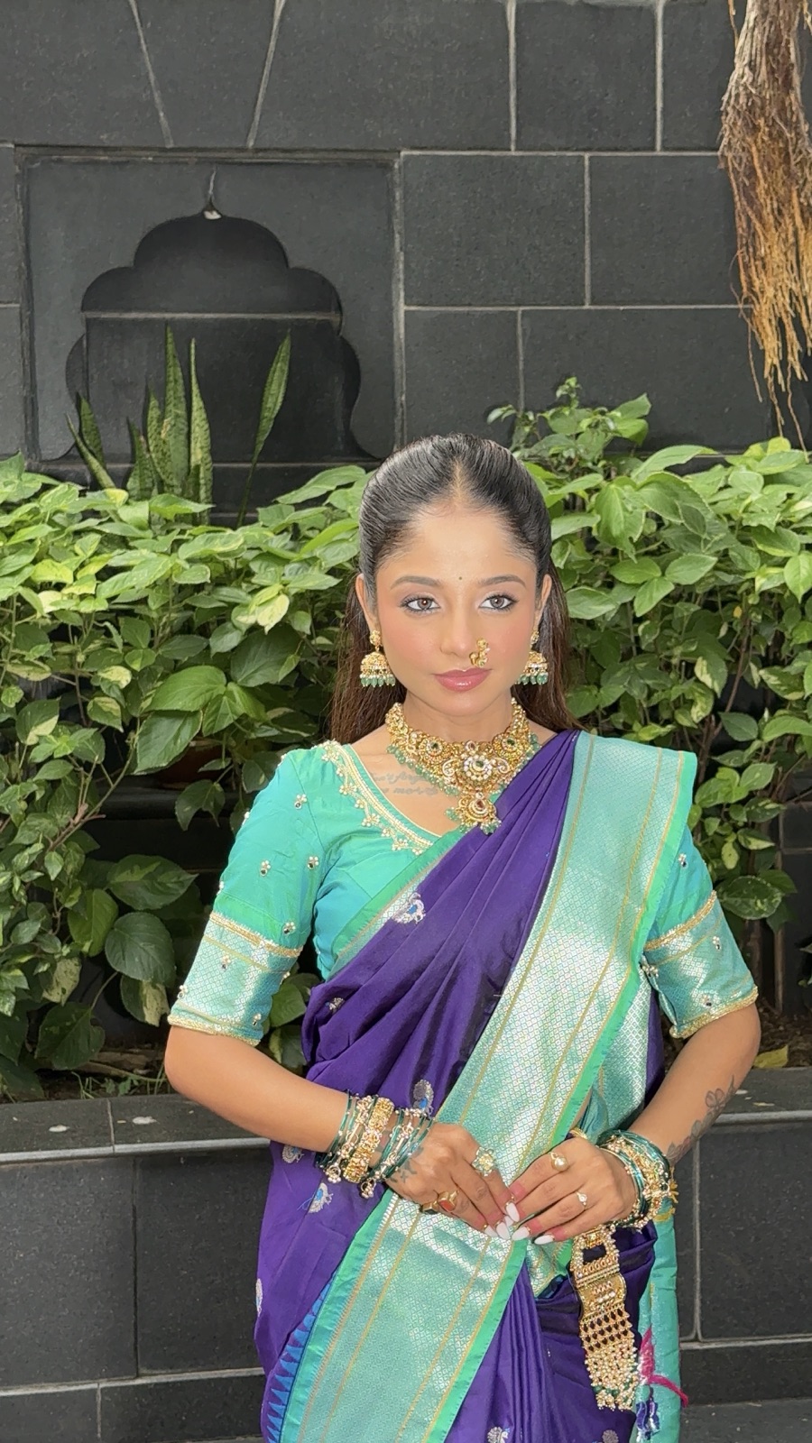 Guest look with glam makeup in a purple-and-teal saree
